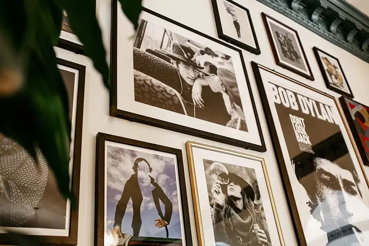 Wall with framed black-and-white photos and a Bob Dylan poster.